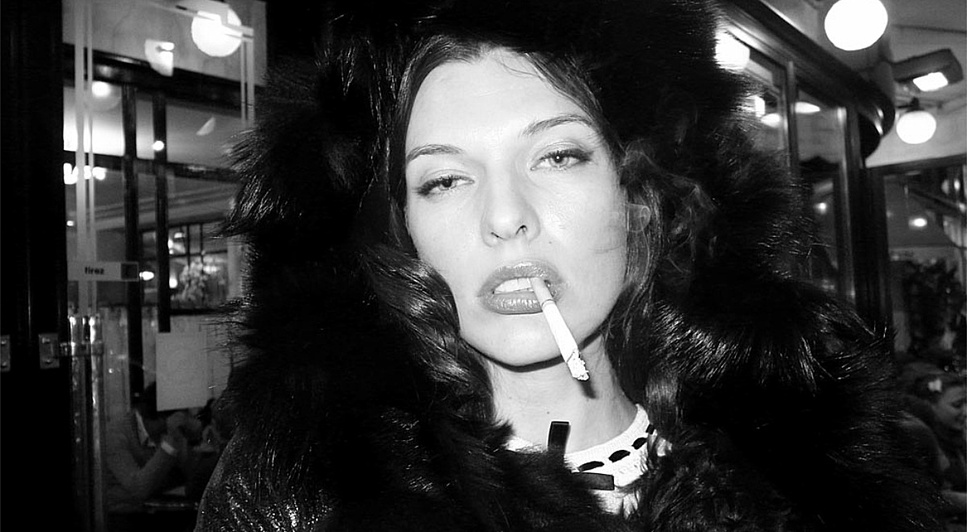 Woman. Black. White.: Milla Jovovich smoking outside the Café de Flore, Paris. Photo Olivier Zahm