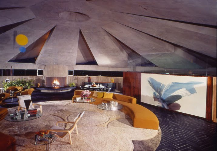 John Lautner: The living room pavilion of the Elrod Home was originally enclosed in glass, but desert storm winds blew out the glass-pane walls in 1971. Lautner said he knew the blowout was a possibility, but he decided to take the risk. After the windstorm shattered the glass, the pavilion was left as a completely open space. The owner liked the effect so much that instead of replacing the panes, he asked Lautner to open the pavilion by designing retractable glass doors. There are now two mechanized 25-foot doors fabricated by an aircraft manufacturer.
