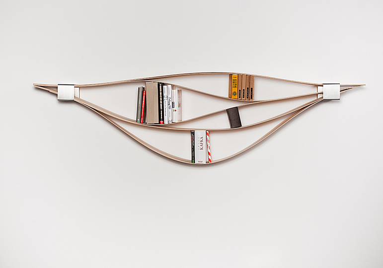 Quite Smart furniture: Chuck is a shelving system which was created inspired by the idea to create individually flexible room. 

At first glance a simple wooden wall shelf, at closer inspection a shelving system made up of flexible wooden planks that is adapting to the objects it preserves and displays. Chuck consists of six wooden planks with two stainless steel locking collars placed at the ends. 

Chuck allows to experience intermediate room, to exploit the possibilities of the elements and to design individual room. The planks of wood can be lifted separately in order to display your favorite items. Depending on the quantity when filled, the planks stretch out and the wall shelf takes on a different shape. 

The result is an intriguing interaction of flexibility and stability, a structure of waves that rise and fall which easily creates room for all of your favourite items. 

Material: plywood, stainless steel.