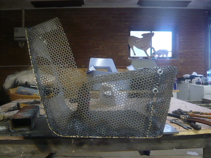 Making a Cool Chair, Davidson: The chair is made from several panels which are hand cut and formed from perforated steel sheets. 