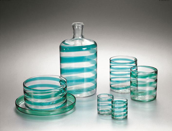 Carlo Scarpa for Venini: Bottle, glasses, tray, and small bowl in clear uncolored a spirale glass with aquamarine (acquamare) decoration, ca. 1936. Lent by The Steinberg Foundation, Courtesy of The Corning Museum of Glass *Part of the A Cerchi, A Fasce, A Spirale Series, ca. 1936-1938