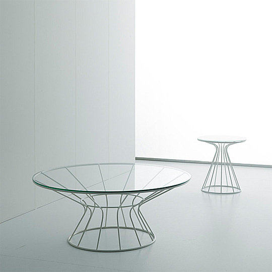 New furniture: Enrico Zanolla:
Sirio is a collection of coffee tables and stool. The structure is restrained by a circle giving the impression of being chocked. They are available in different colours with top in glass and upholstered seat for stool.