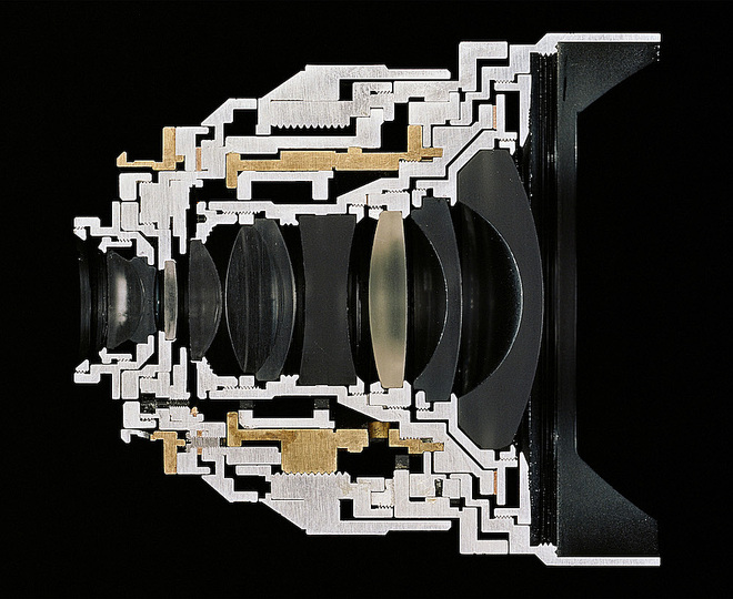 The Production Line of Happiness: Christopher Williams (American, born 1956). Cutaway model Zeiss Distagon T* 2.8/15 ZM / Focal length: 15mm. Aperture range: 2.8 – 22. No. of elements/groups: 11/9 / Focusing range: 0.3 m–infinity. Image ratio at close range: 1:18 / Coverage at close range: 43 cm × 65 cm. Angular field, diag./horiz./vert.: / 110/100/77˚ / Filter: M 72 × 0.75. Weight: 500 g. Length: 86 mm / Product no. black: 30 82016. Serial no.: 15555891. / (Subject to change.) / Manufactured by Carl Zeiss AG, Camera Lens Division, Oberkochen, Germany / Studio Rhein Verlag, Düsseldorf / January 18, 2013. 2013. Pigmented inkjet print. Paper: 16 × 20″ (40.6 × 50.8 cm); framed: 30 1/2 × 33 3/8″ (77.5 × 84.8 cm). Private collection © Christopher Williams