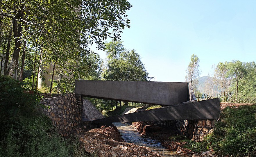 A Bridge: The design of the bridge involves a singular loop linking two levels of the riverbank and an additional arm connecting across the river. 