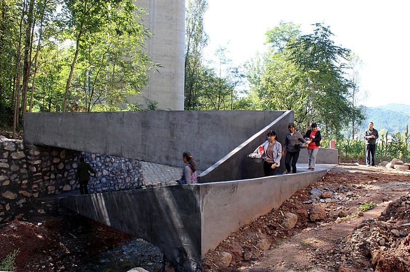 A Bridge: Nowadays the villagers are able to commute freely across the river and meet at the bridge for trade and commerce. The bridge has become a social hub for the village.