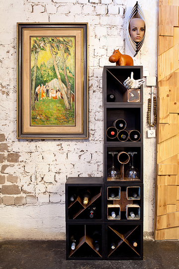 A Charming artistic loft in Tel Aviv, Israel: Lithogrphy, modular wine storage unit. wooden box with rusted metal.