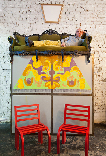 A Charming artistic loft in Tel Aviv, Israel: This wood partition turned into installation when Alon put on top of it an old, Baroque style sofa which he found on the street