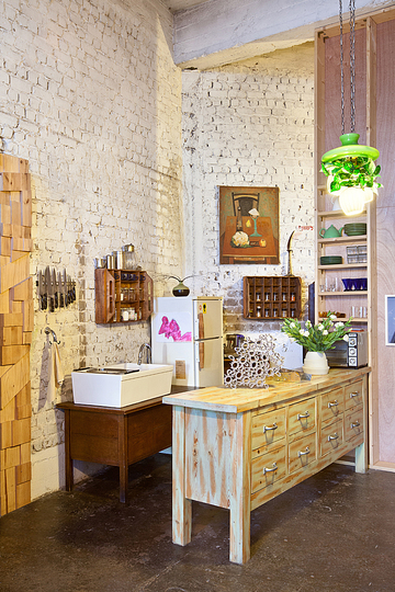 A Charming artistic loft in Tel Aviv, Israel: The kitchen was built around a central wooden cabinet designed by Razgour