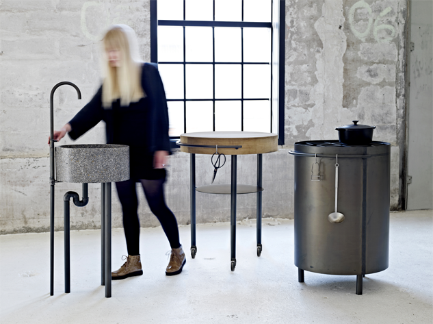 New design ideas for kitchens and cooking: EtKøkken, which is Danish for “a kitchen”, separates three basic functions of cooking into three freestanding stations - water, fire and chopping block.
The starting point was a desire to challenge todays kitchen! The round shape of the three sta- tions is inspired by the shape of a firepit, where people gather in 360°.
A circle of material framed in blackened steel de- fines each station: Oak for the chopping block, marble terrazzo for the skin and a crisscrossing pattern of steel for the gas cooktop.
The waterstation has to be connected to water and drainage, while the blockstation and the firestation sits on castors, so they can be easily moved and adapted for different constellations – inside or outside. The stations each have a ring attached on the side for the primary cooking tools.