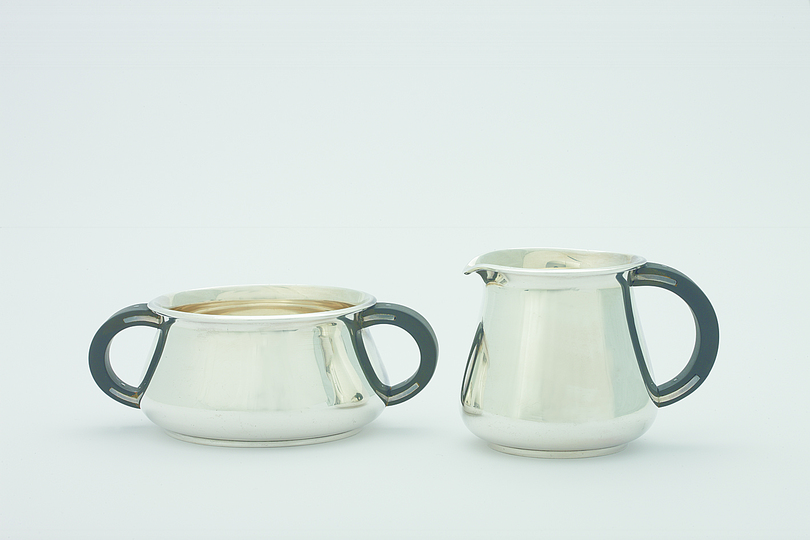 20th Century Silver Tea and Coffee Sets: Sugar bowl (on the left) and cramer are designed by Svend Weihrauch and crafted by Frantz Hingelberg. Production year: 1934/35. Material: pressed and embossed silver and ebony wood. Courtesy: Grassi Museum für Angewandte Kunst, Leipzig. Photo: Christoph Sandig.
