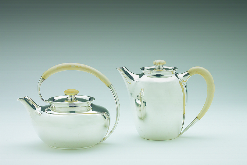20th Century Silver Tea and Coffee Sets: Tea pot (on the left) and Coffee pot (on the right) manufactured by Danish silversmith Carl Mads Cohr in the 1950s. Bodies are made of pressed and embossed silver and handles are made of ivory. Courtesy: Grassi Museum für Angewandte Kunst, Leipzig. Photo: Christoph Sandig.