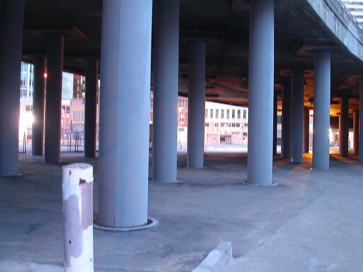 Non-place, Space between: Car space: A stunning amount of Space Between in cities is forgotten space: Space below overpasses, in and next to parking lots and in between roads. 