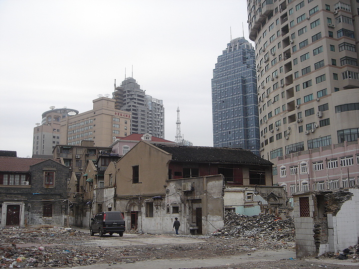 Non-place, Space between: Erased space: Old hutong buildings in Beijing, China. There can be a timespan of many years in between old structures being erased for future developments (of the sort seen in the background) and the actual construction of new buildings.